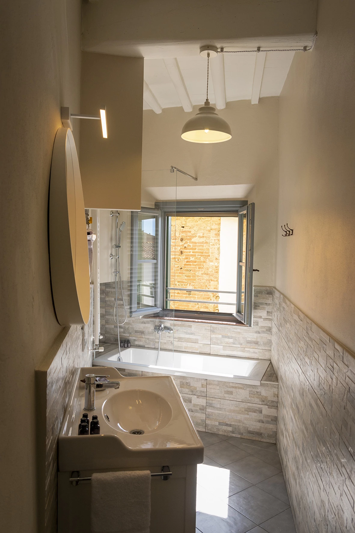 View of a bathroom with a window and scenic view at Ridolfo House in San Miniato